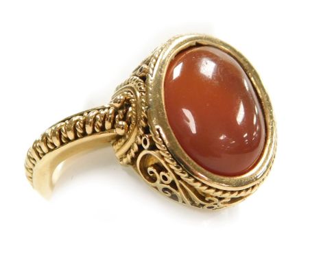A Continental gentleman's cornelian cabochon signet ring,  in yellow metal with filigree decoration, size R, 9.2g.