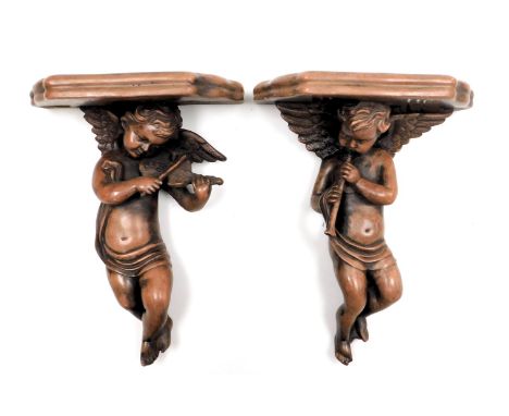 A pair of plaster wall shelves, modelled as cherubs playing musical instruments, 33cm high.