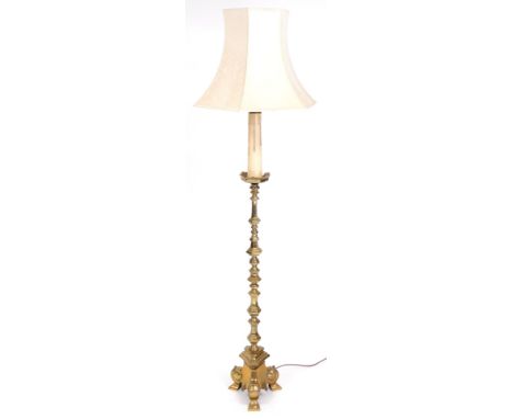 A brass standard lamp, of Gothic altar form, with a floral cream shade, 174cm high.