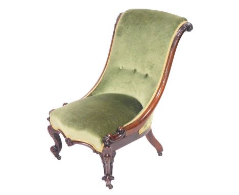 A Victorian rosewood nursing chair, upholstered in button back green draylon, raised on cabriole, legs on castors, 52cm wide.