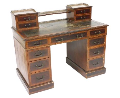 A late Victorian mahogany and satinwood cross banded twin pedestal desk, with an upper gallery super structure on a tooled le