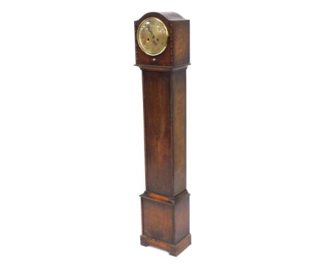 An mid 20thC oak grandmother clock, the circular dial bearing Arabic numerals, eight day movement with coil strike, the case 