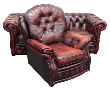 An ox blood leather Chesterfield sofa, with button back and arms, loose cushion seats, raised on bun feet, 200cm wide, togeth