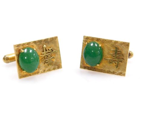 A pair of Chinese cabochon jade set cuff links, on a rectangular face bearing a raised single character, stamped 14K, 9.5g. 