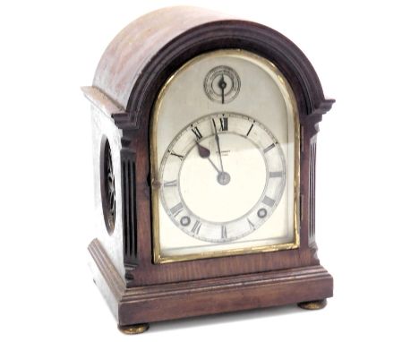 An early 20thC mahogany cased mantel clock, for Geo. Tarratt Leicester, arched silver dial with chapter ring bearing Roman nu