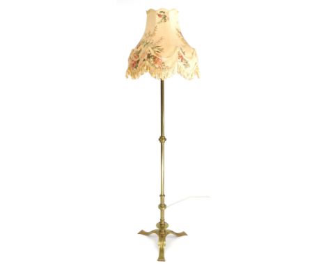 An early 20thC electrolier brass standard lamp with a floral shade, 214cm high.