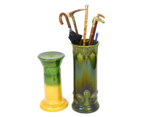 A late Victorian pottery jardiniere stand, in two tone green and yellow, with moulded decoration, 51cm high, together with a 