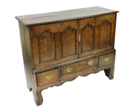 A Georgian oak linen press, possibly Welsh, with a pair of panelled doors opening to reveal a single shelf, above one long an