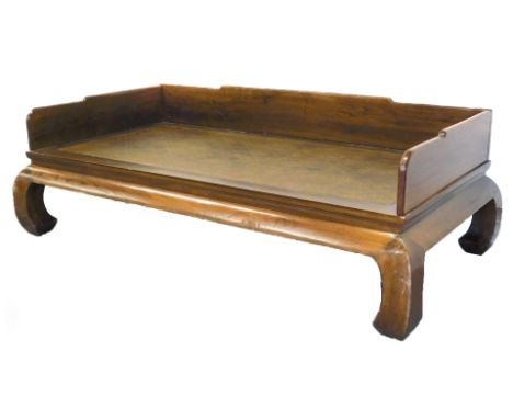 A Qing Dynasty late 19thC Chinese elm and rattan opium day bed, with a galleried back and sides, raised on scroll legs, 218cm