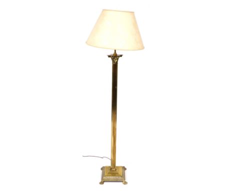 A brass Corinthian column standard lamp,  raised on a stepped square base, with a floral cream fabric shade, 162cm high.