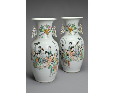 A MIRRORED PAIR OF CHINESE FAMILLE ROSE PORCELAIN VASES, 20TH CENTURY. Of baluster form with gilt handles decorated with ladi