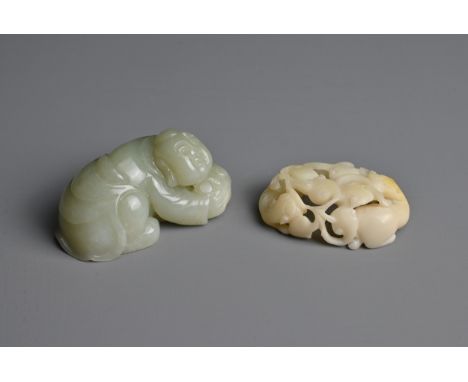 TWO CHINESE JADE AND STONE CARVINGS. To include a pale celadon nephrite jade figure of a boy crouched over a lotus spray; Tog