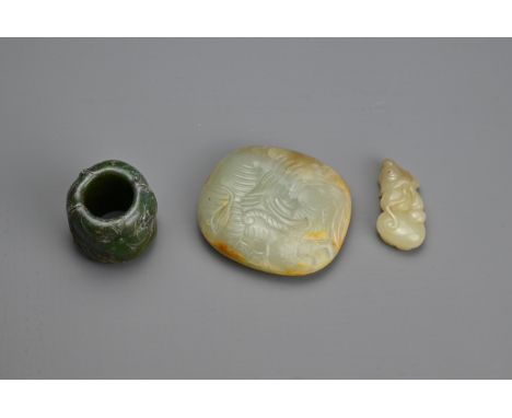 THREE CHINESE CARVED JADE ITEMS. To include a celadon jade belt plaque carved in relief with figure of an elephant; A thumb r