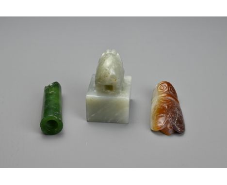 THREE CHINESE CARVED JADE ITEMS. To include a square seal surmounted by an elephant and incised four character mark; A cicada