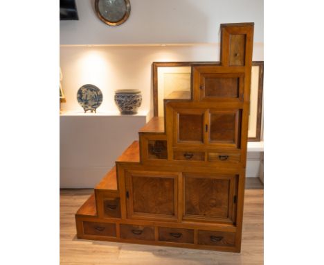 EARLY 20TH CENTURY JAPANESE/KOREAN ELMWOOD STEPPED CABINET, in two sections, top faux drawer above a cupboard door, leading d