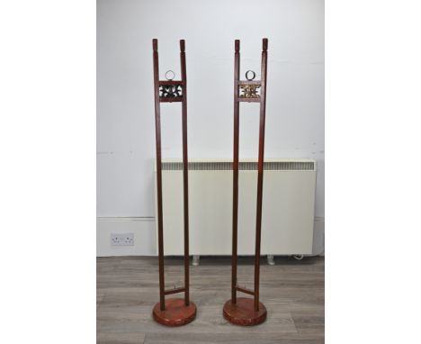 A LARGE PAIR OF CHINESE RED LACQUERED HANGING CANDLESTICK HOLDER STANDS, EARLY 20TH CENTURY. Each circular base is carved in 