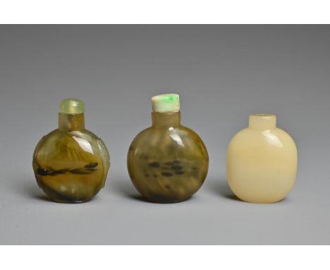 THREE CHINESE GLASS IMITATION AGATE SNUFF BOTTLES. Each of flattened globular ovoid form, one with twin mask handles in relie