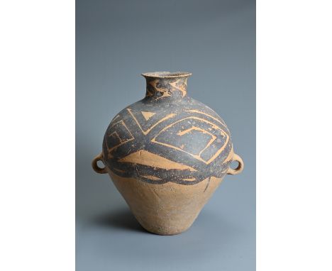 A LARGE CHINESE NEOLITHIC MACHANG PAINTED POTTERY JAR. Heavily potted with two wide lug handles at the waist decorated in red