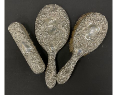A three piece silver dressing table set, planished Birmingham, 1899, (3).