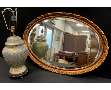 Interior design - an urnular shaped table lamp, and an oval Guilt framed mirror, (2).