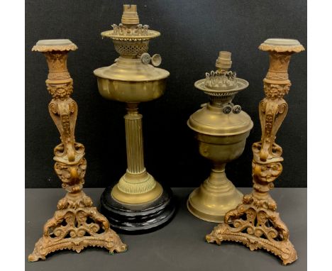 A pair of cast iron Italianate Baroque gilt metal candlesticks, mask head scrolling columns, caryatid Mermaid base, 39.5cm hi