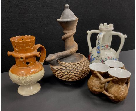 Ceramics - a Denby Langley puzzle jug, a set of late 19th century fuddling cups, a 19th century hand painted puzzle jug, poss