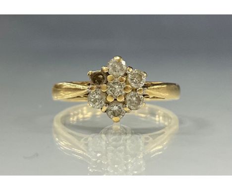 A diamond daisy head seven stone cluster ring, total diamond weight 0.50ct, 18ct gold shank, size N, 3.5g gross (1 stone miss