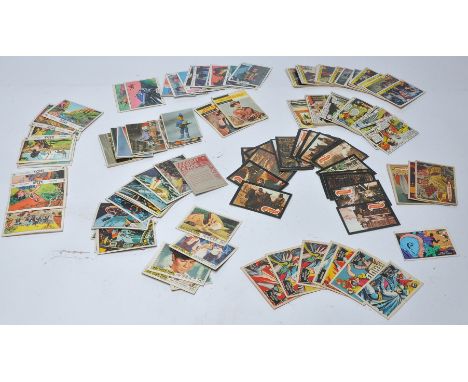 A collection of vintage trading cards featuring issues for Superman, Batman, Captain Scarlet, Thunderbirds, Planet of the Ape