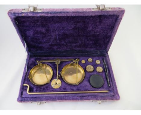 An apothecary weighing scales set.