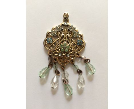 A vintage yellow metal pendant.
 