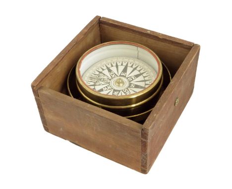A compass, the 5 inch paper dial in a brass bowl gimballed within a boxwood box, with sliding lid, box 8in square.