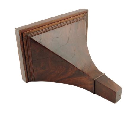 A mahogany bracket, 20th century, the concave body with flame veneer, 13.5in (34cm) high, 14in (35cm) wide.