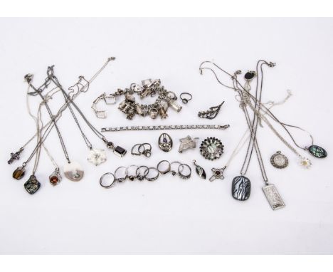 A collection of silver jewels, including rings, plain and some set, hard stone and paste pendants, a mother of pearl bangle, 