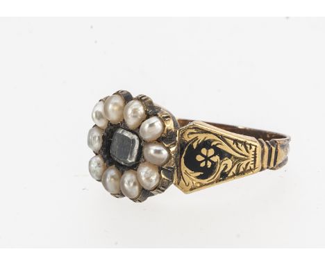 A 19th century mourning ring, centred with plaited hair panel, surrounded by seed pearls, and enamel engraved shoulders flora