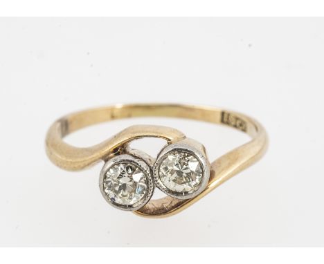 An 18ct yellow gold diamond crossover ring, old cuts in rubbed over plat settings, pierced design, ring size J, diamond weigh