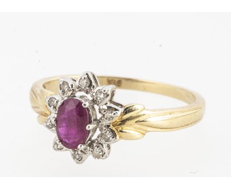 A 14k marked ruby and diamond cluster ring, oval mixed cut ruby in claw setting surrounded by small eight cut diamonds. Ruby 