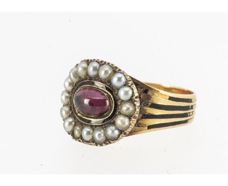 An early 19th century dated and inscribed mourning ring, set with a cabochon garnet surrounded by a band of black enamel, and