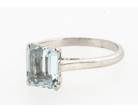 A marked 18ct gold aqua marine single stone dress ring, the step cut in four claw setting, all in white metal marked 18ct, aq