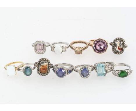 A collection of silver and coloured gem set rings including two moss agate examples, others included simulated opal and other