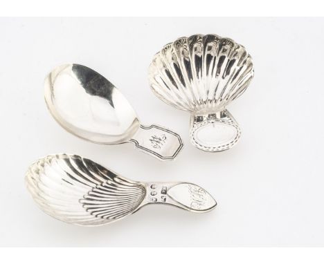 Three George III period silver tea caddy spoons, one with plain bowl and initials to handle, another with shell shaped bowl a