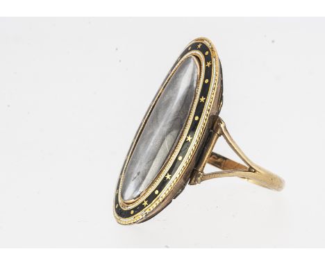 An 18th century Georgian mourning ring, dated and named, oval panel of finely plated checked hair, framed under lead crystal,