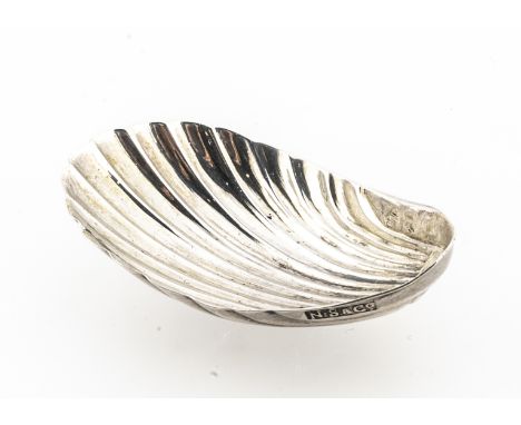 A George III period silver tea caddy spoon by Nathaniel Smith &amp; Co, 4.9cm and 4.8g, shell shaped, marks unclear for date 