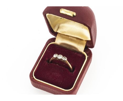 An 18ct &amp; Platinum three stone old cut diamond ring, the three old cuts in rubbed over settings on yellow metal shank, ri