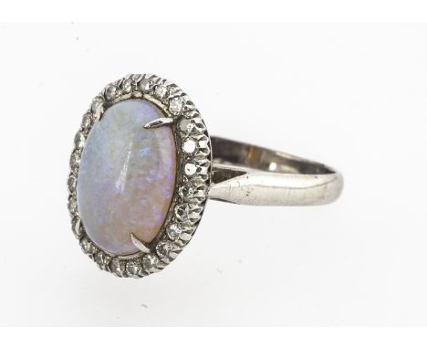 An opal and diamond white gold dress ring, the oval cabochon white precious opal, surrounded by brilliant cut diamonds, ring 