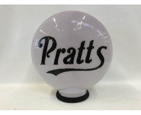 An early Pratts pill shaped glass petrol pump globe, two chips under rubber ring to the neck.