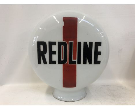 A Redline pill shaped glass petrol pump globe, the letters possibly overpainted some time ago.