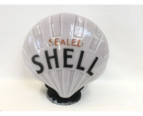 An early Sealed Shell glass petrol pump globe with repaired patch to one side.