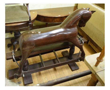 A carved hardwood rocking horse, 130 cm wide

 