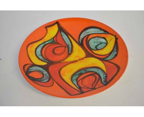 Good quality Poole Pottery charger with an orange ground, decorated with green, yellow and red swirl to centre, printed mark 