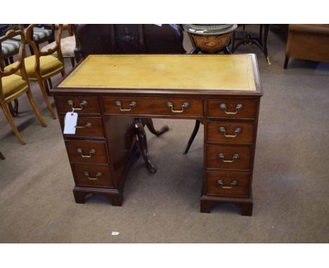 George II style kneehole desk, fitted with five drawers, with brass swan neck handles raised on bracket feet, with heavy bras